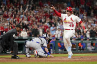 St. Louis Cardinals' Harrison Bader (48) celebrates as he scores past New York Mets catcher Tomas Nido and home plate umpire Alan Porter (64) during the eighth inning of a baseball game Monday, April 25, 2022, in St. Louis. (AP Photo/Jeff Roberson)