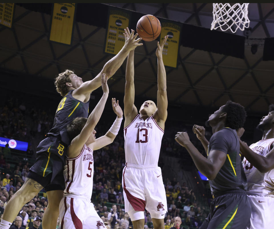 Arkansas guard Jordan Walsh (13) pulls down a rebound over Baylor forward Caleb Lohner (33) in the first half of an NCAA college basketball game, Saturday, Jan. 28, 2023, in Waco, Texas. (Rod Aydelotte/Waco Tribune-Herald via AP)