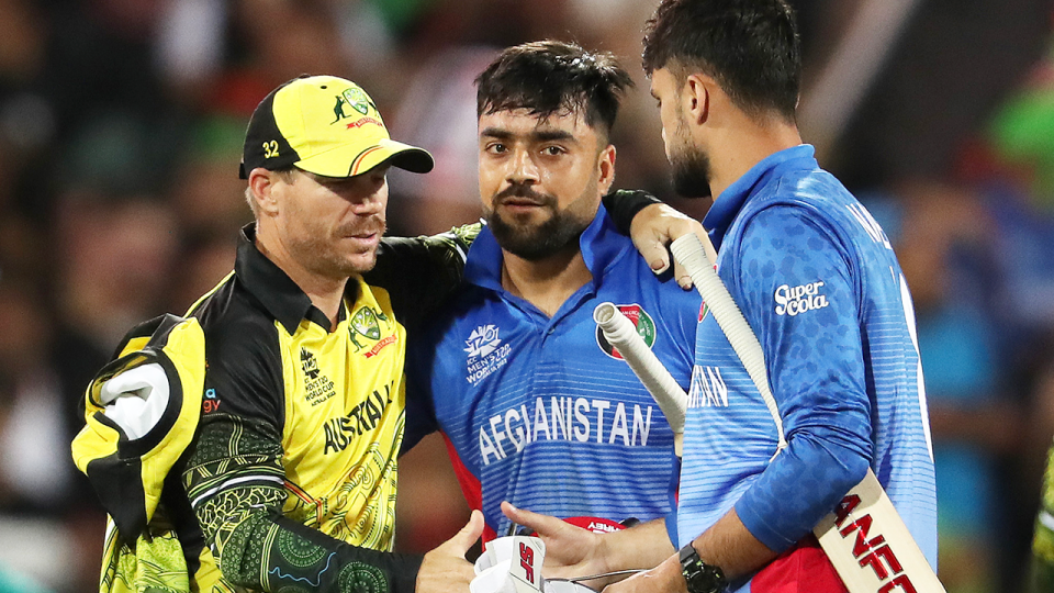 David Warner (pictured left) embraces Afghanistan players Rashid Khan and Naveen ul haq Murid after a match.