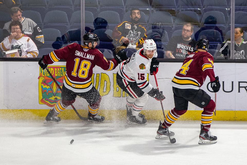 Rockford's Carson Gicewicz dishes the puck off during the IceHogs' Game 1 loss to the Chicago Wolves in Rosemont on Thursday, May 12, 2022.