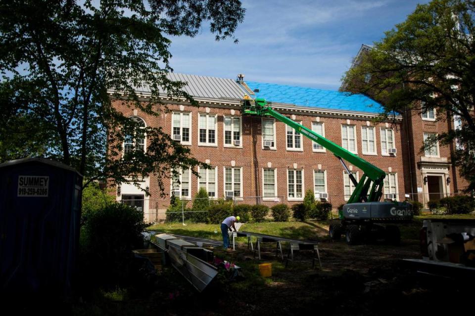 A roofing crew installs a new metal roof on the Durham School of the Arts, on Tuesday, Apr. 20, 2021, in Durham, N.C.