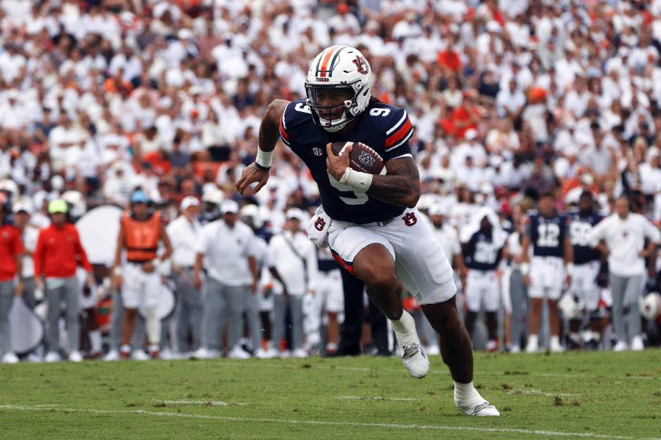 Auburn quarterback Robby Ashford carries the ball in for a touchdown against Massachusetts during the first half of an NCAA college football game Saturday, Sept. 2, 2023, in Auburn, Ala. (AP Photo/Butch Dill)