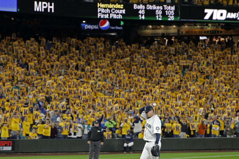 Fans hold up "K" signs hoping for a strikeout as Seattle Mariners starting pitcher Felix Hernandez prepares to throw a pitch during the sixth inning in the team's baseball game against the Oakland Athletics, Thursday, Sept. 26, 2019, in Seattle. Hernandez was pulled after the next pitch in his final start of the season. (AP Photo/Ted S. Warren)