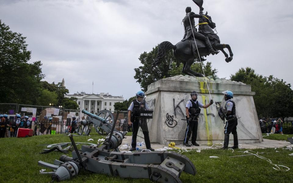 Park Police stand guard after protesters attempted to pull down the statue - Tasos Katopodis/Getty Images