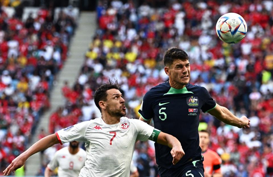 TOPSHOT - Tunisia's forward #07 Youssef Msakni (L) fights for the ball with Australia's defender #05 Fran Karacic (R) during the Qatar 2022 World Cup Group D football match between Tunisia and Australia at the Al-Janoub Stadium in Al-Wakrah, south of Doha on November 26, 2022. (Photo by Anne-Christine POUJOULAT / AFP) (Photo by ANNE-CHRISTINE POUJOULAT/AFP via Getty Images)