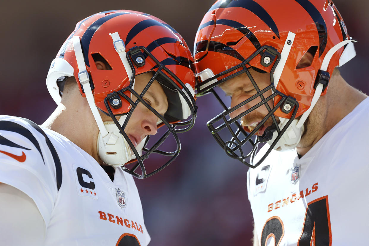 Cincinnati Bengals quarterback Joe Burrow (9) headbumps center Ted Karras (64) warms up before an NFL football game against the San Francisco 49ers in Santa Clara, Calif., Sunday, Oct. 29, 2023. (AP Photo/Josie Lepe)