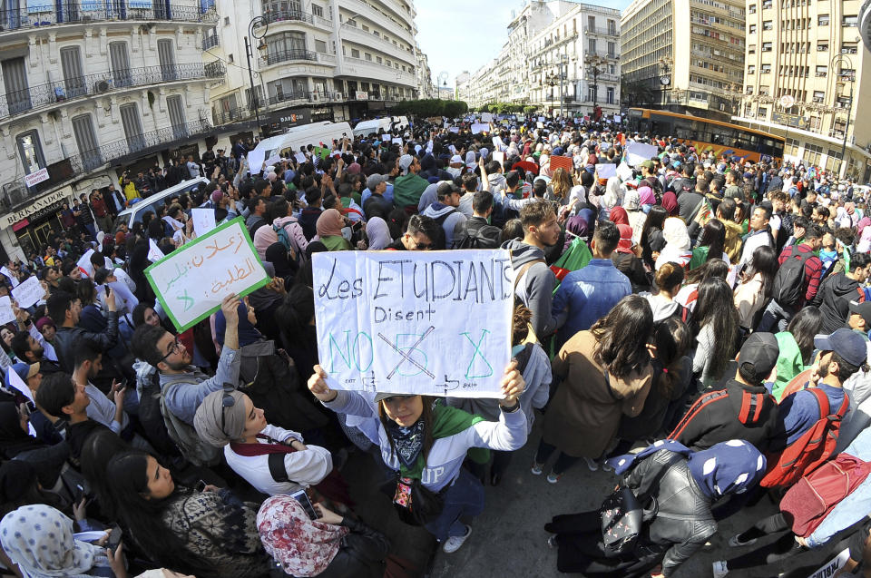 Hundreds of students gather in central Algiers to protest Algerian President Abdelaziz Bouteflika's decision to seek fifth term, Tuesday, March 6, 2019. Algerian students are gathering for new protests and are calling for a general strike if he doesn't meet their demands this week. Poster reads "Students say No to a fifth term". (AP Photo/Fateh Guidoum)