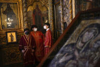 Orthodox Christian altar boys talk during the Epiphany mass at the Patriarchal Church of St. George in Istanbul, Turkey, Thursday, Jan. 6, 2022. Christians around the world on Thursday marked Epiphany, known as the Three Kings Day for Catholics and the Baptism of Christ for the Orthodox, with a series of celebrations. (AP Photo/Francisco Seco)