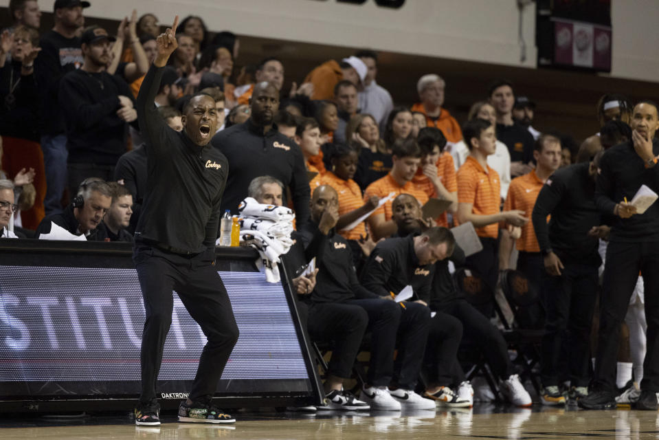 Oklahoma State head coach Mike Boynton Jr., front left, reacts on the sideline during the second half of an NCAA college basketball game against TCU in Stillwater, Okla., Saturday, Feb. 4, 2023. (AP Photo/Mitch Alcala)