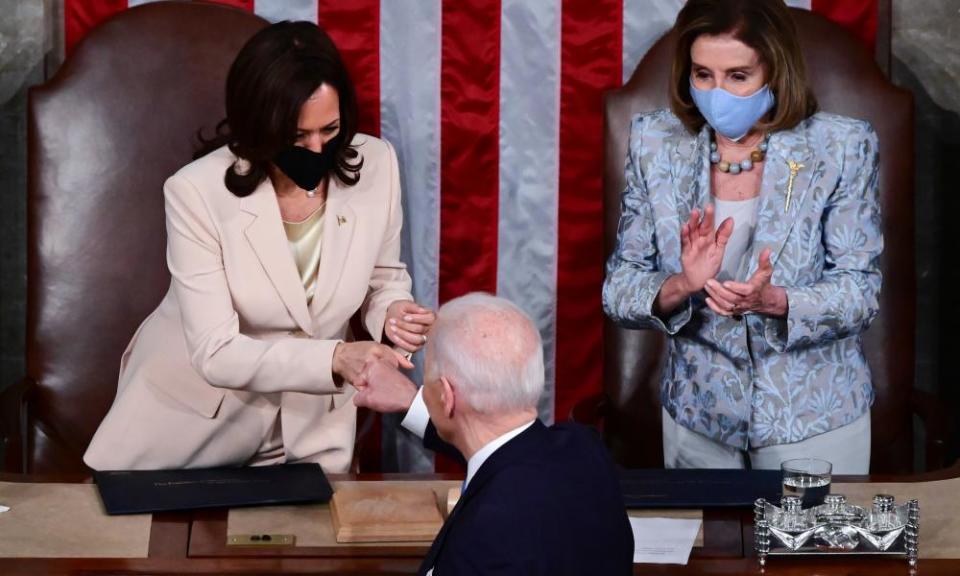 Vice-president Kamala Harris gives Joe Biden a fist bump as House speaker Nancy Pelosi looks on.