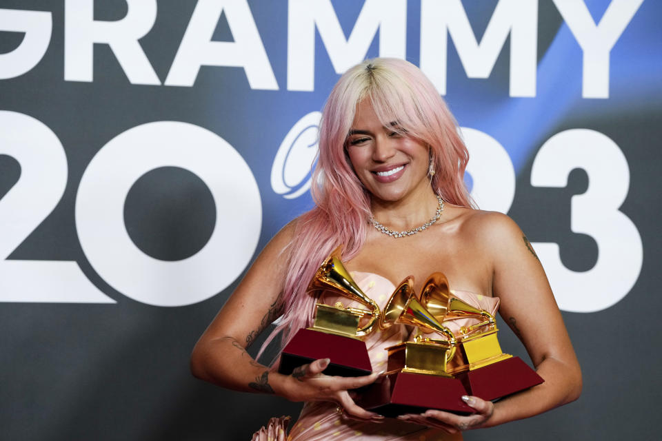 Karol G poses with the awards for best urban album for "Mañana Sera Bonito", for album of the year for "Mañana Sera Bonito" and the award for best urban fusion/performance for "TQG" during the 24th annual Latin Grammy Awards in Seville, Spain, Thursday, Nov. 16, 2023. (Photo by Jose Breton/Invision/AP)