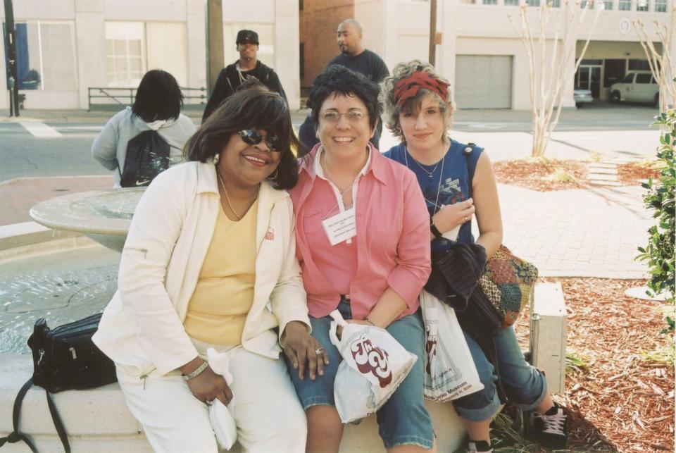 Outside the Rosa Parks Museum, Karen Blair Clay of Raleigh, North Carolina, left, sits with Kathy Flores of Appleton, Wisconsin, and Flores' daughter, Amber Flores.