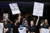 Lido cabaret dancers, other employees and union activists demonstrate to try to save their jobs and the history of the cabaret, known for its dinner theater and its "Bluebell Girls" revue, Saturday, May 28, 2022 in Paris. Amid financial troubles and changing times, the venue's new corporate owner is ditching most of the Lido's staff and its high-kicking, high-glamour dance shows — which date back decades and inspired copycats from Las Vegas to Beirut — in favor of more modest musical revues. (AP Photo/Thomas Padilla)