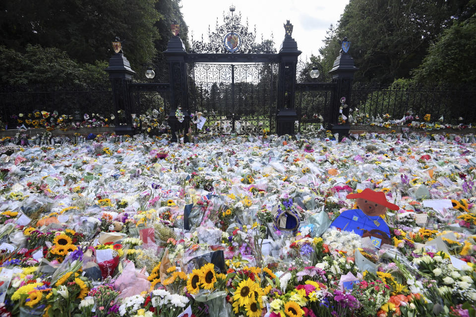 Floral tributes are placed at Norwich Gates by members of the public, in memory of late Queen Elizabeth II, at the Sandringham Estate, in Norfolk, England, Thursday, Sept. 15, 2022. (Toby Melville/Pool via AP)