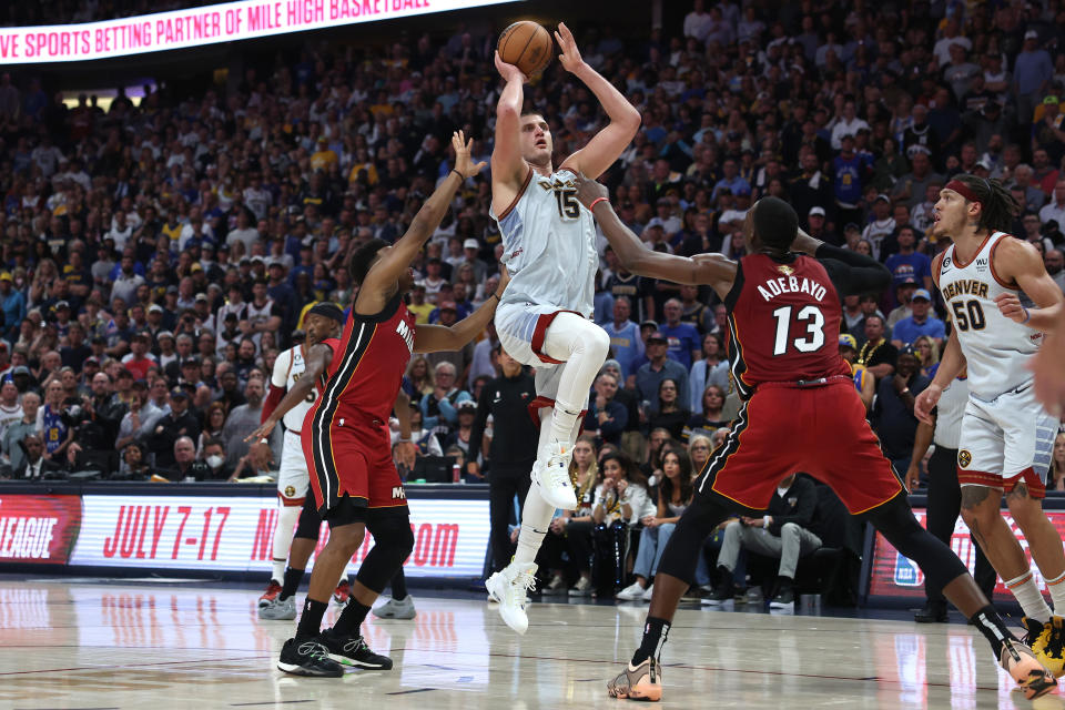 DENVER, COLORADO - JUNE 12: Nikola Jokic #15 of the Denver Nuggets drives the lane against Bam Adebayo #13 of the Miami Heat during the fourth quarter in Game Five of the 2023 NBA Finals at Ball Arena on June 12, 2023 in Denver, Colorado. NOTE TO USER: User expressly acknowledges and agrees that, by downloading and or using this photograph, User is consenting to the terms and conditions of the Getty Images License Agreement. (Photo by Matthew Stockman/Getty Images)