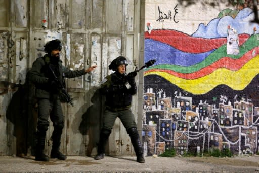 Israeli soldiers clash with Palestinian protesters during an incursion into the West Bank city of Ramallah on January 7, 2019