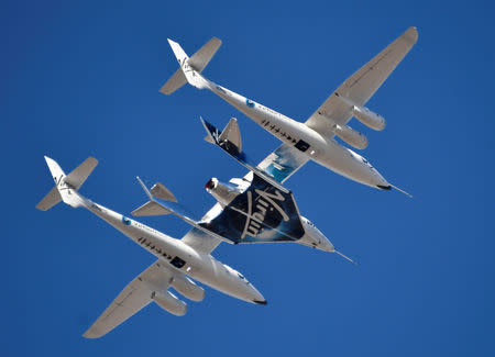 Virgin Galactic rocket plane, the WhiteKnightTwo carrier airplane, with SpaceShipTwo passenger craft takes off from Mojave Air and Space Port in Mojave, California, U.S., February 22, 2019. REUTERS/Gene Blevins