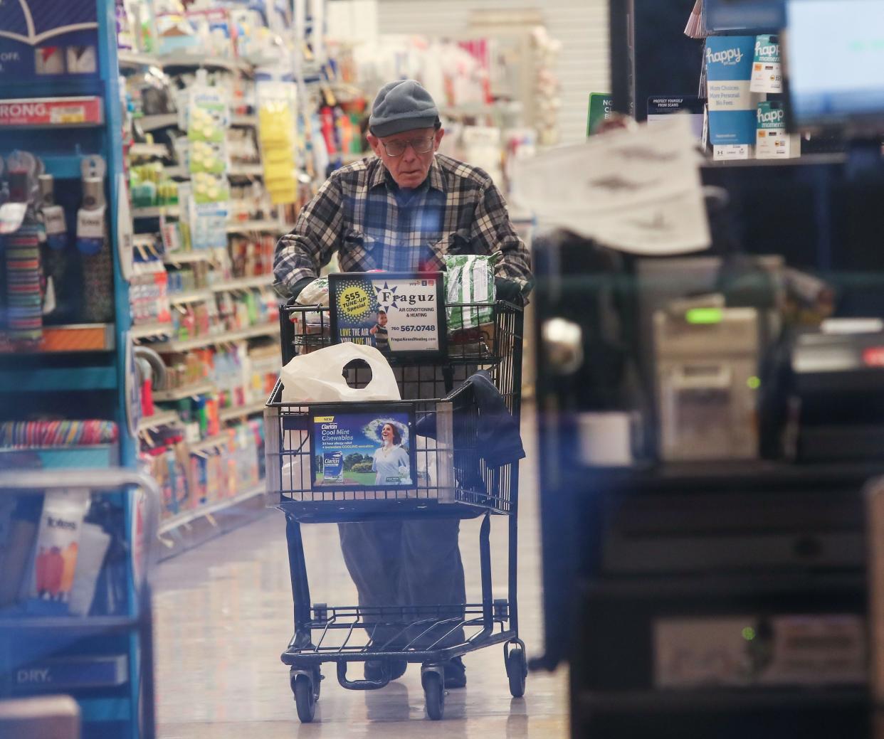 A man shops at Vons grocery in Palm Springs, March 18, 2020.