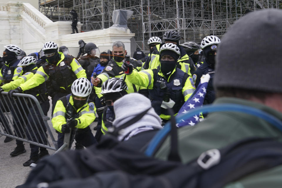 In this Wednesday, Jan. 6, 2021, photo, violent rioters try to break through a police line on the West Front of the Capitol, in Washington. The top watchdog for the U.S. Capitol Police will testify to Congress for the first time about the department’s broad failures before and during the Jan. 6 insurrection. Among them was missed intelligence and old weapons that officers didn’t feel comfortable using. (AP Photo/John Minchillo)