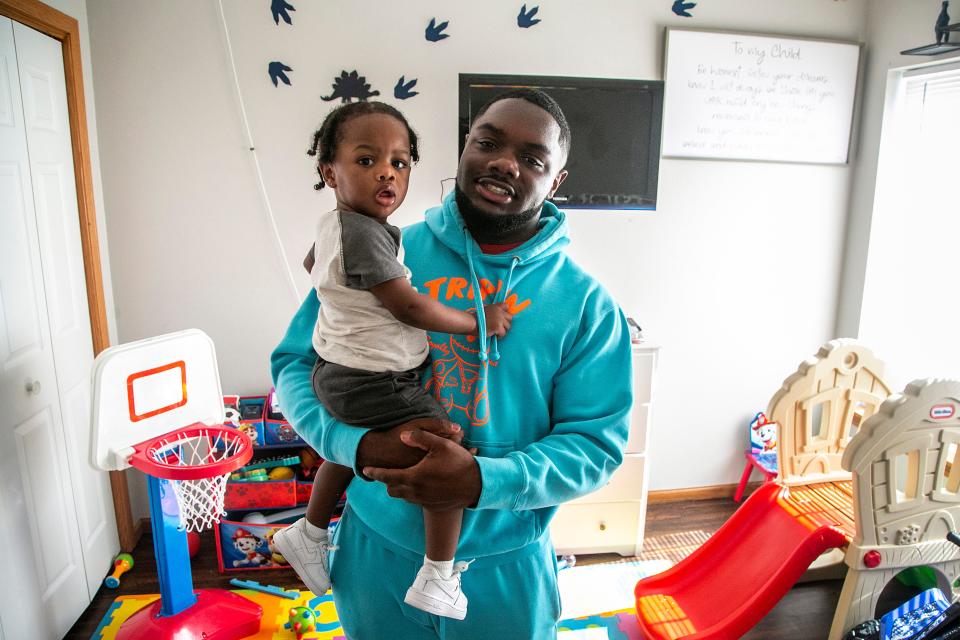 Davonte Foster, 22, poses for a photo with his son Legend, 1, Thursday, June 16, 2022, in Iowa City, Iowa.