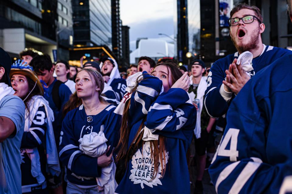 Fans react during Game 7 of an NHL hockey first-round playoff series between the Toronto Maple Leafs and the Tampa Bay Lightning in Toronto, Saturday May 14, 2022. (Christopher Katsarov/The Canadian Press via AP)