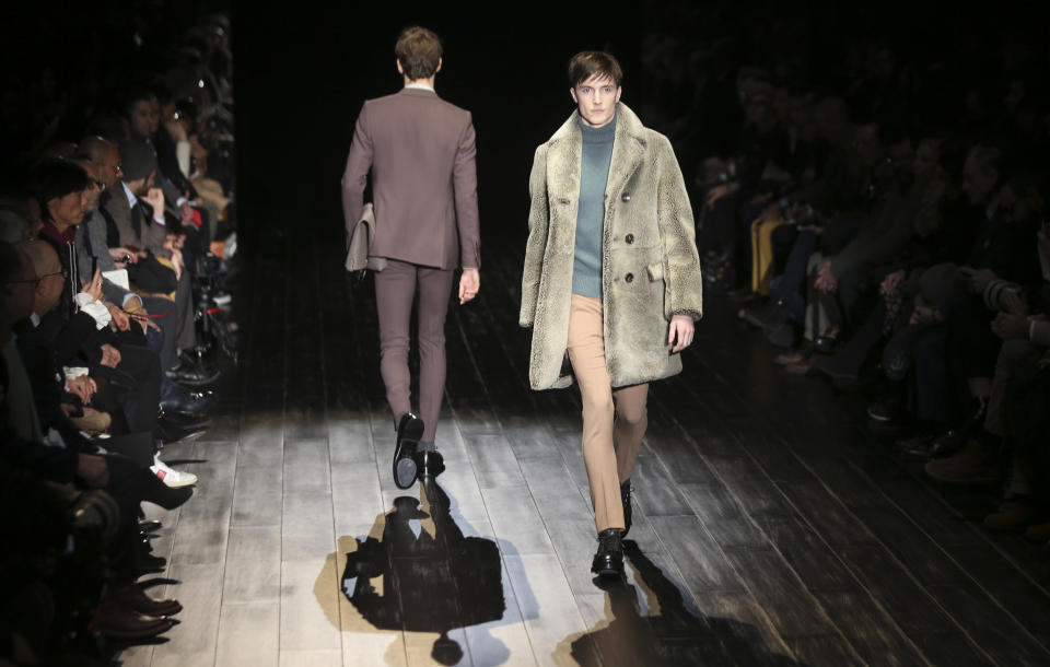 Models wear creations for Gucci men's Fall-Winter 2014 collection, part of the Milan Fashion Week, unveiled in Milan, Italy, Monday, Jan.13, 2014. (AP Photo/Luca Bruno)