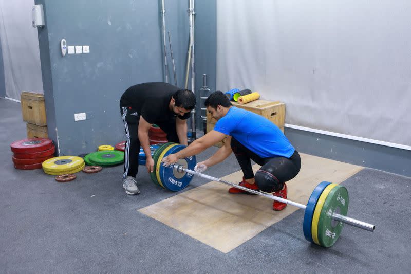 Gaza weight-lifter Mohammad Hamada who is the first Palestinian to compete in the game at the Olympics when it kicks off in Tokyo, practices at a gym in Doha