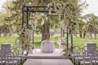 <p>The modern Chuppah was adorned with the couple’s favorite flowers: white Tibet roses, white hydrangeas, and flowing orchids, all spun into a chic asymmetrically architectural design. </p>