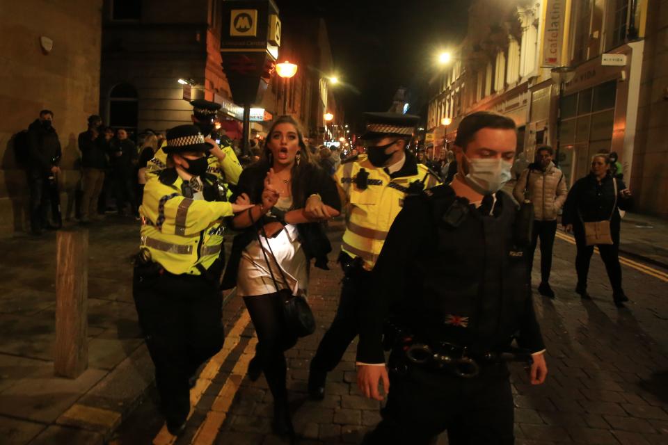 Police patrol as revellers enjoy a night out in the centre of Liverpool, north west England on October 10, 2020 ahead of new measures set to be introduced in the northwest next week to help stem the spread of the novel coronavirus. - Prime Minister Boris Johnson is expected to outline the new regime on Monday as rates of Covid 19 infection surge particularly in the north, worsening a national death toll of more than 42,000 which is already the worst in Europe. (Photo by Lindsey Parnaby / AFP) (Photo by LINDSEY PARNABY/AFP via Getty Images)