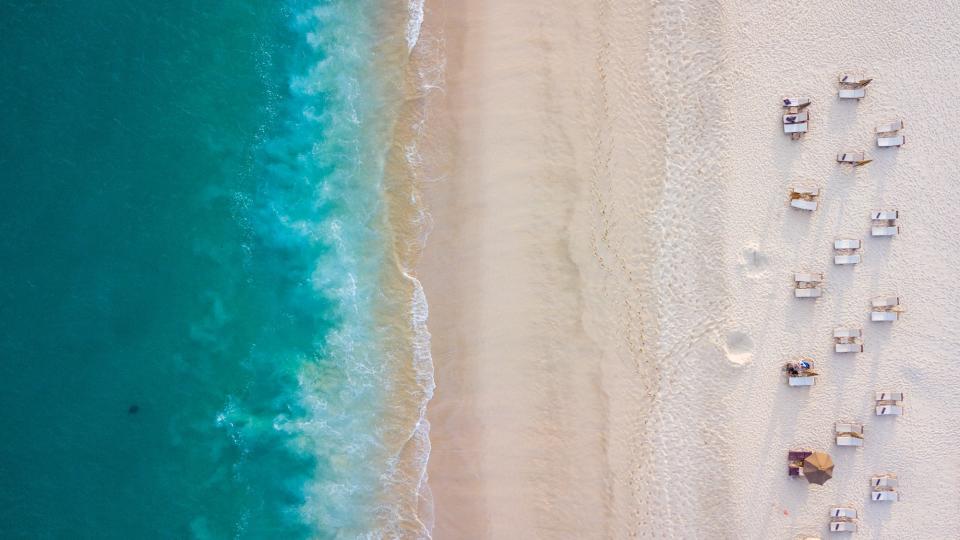 An aerial view of the turquoise water and sandy beach in Cabo San Lucas, Mexico