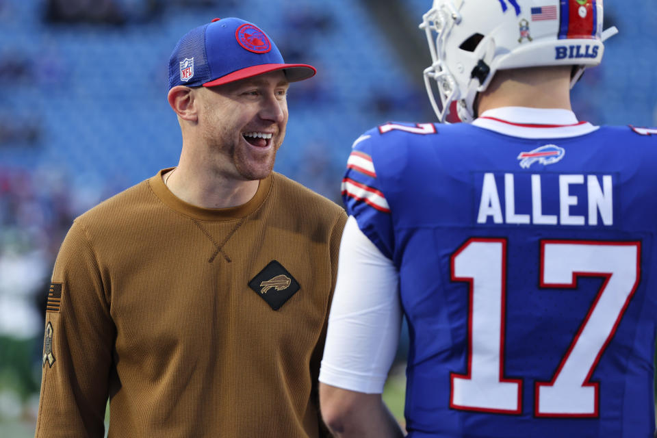 Buffalo Bills interim offensive coordinator Joe Brady, left, participates in warmups before the team's NFL football game against the New York Jets in Orchard Park, N.Y., Sunday, Nov. 19, 2023. (AP Photo/Jeffrey T. Barnes )