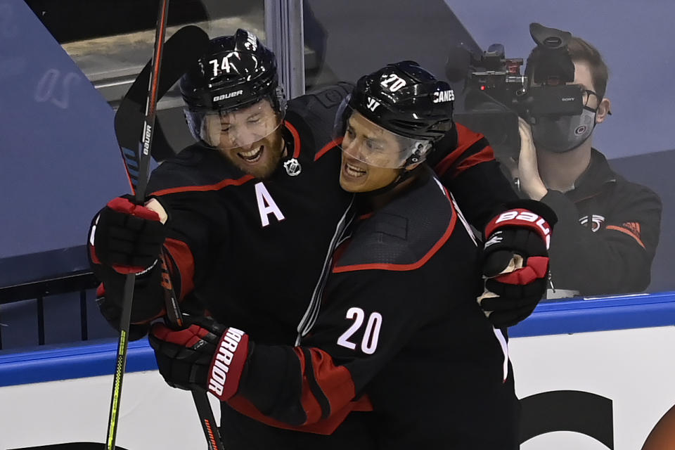 Carolina Hurricanes defenceman Jaccob Slavin (74) celebrates his goal against the New York Rangers with teammate Sebastian Aho (20) during the first period in the NHL hockey Stanley Cup playoffs in Toronto, Saturday, Aug. 1, 2020. (Frank Gunn/The Canadian Press via AP)