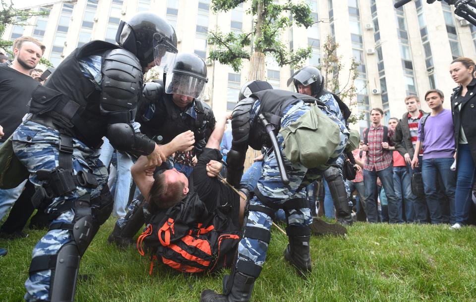 Russian police officers detain a participant.&nbsp;