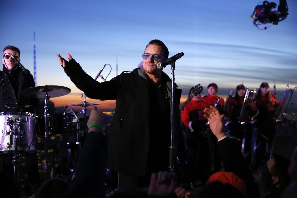 In this photo provided by NBC, U2 performs "Invisible," atop the G.E Building during "The Tonight Show" on Monday, Feb. 17, 2014, in New York. Jimmy Fallon made his debut Monday as the host of “The Tonight Show,” replacing Jay Leno after 22 years. (AP Photo/NBC, Lloyd Bishop)