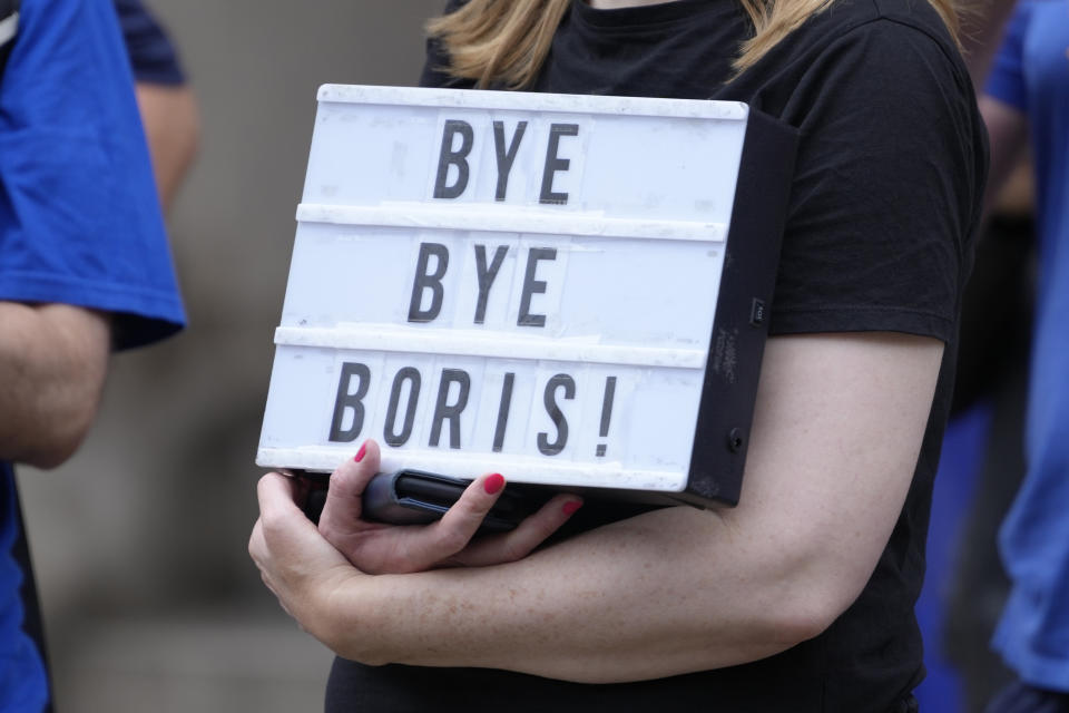 A woman holds a placard during a demonstration in Westminster, before the announcement of the result of the Conservative Party leadership contest at the Queen Elizabeth II centre, in London, Monday, Sept. 5, 2022. The governing Conservative Party will announce later on Monday whether Foreign Secretary Liz Truss or former Treasury chief Rishi Sunak won the most votes from party members to succeed Boris Johnson as party leader and British prime minister. (AP Photo/Kirsty Wigglesworth)