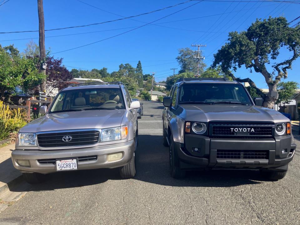 An older Toyota Land Cruiser (left) is parked on a suburban street in Silicon Valley next to a new version.