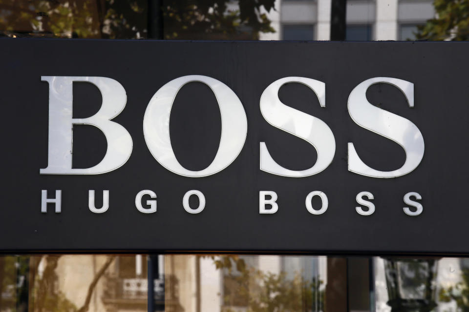 The logo of Hugo Boss, a German luxury fashion house is pictured on the Champs Elysees Avenue in Paris, France, Wednesday, Sept. 20, 2017. (AP Photo/Francois Mori)