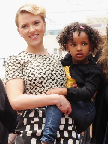 <p>Jon Kopaloff/FilmMagic</p> Scarlett Johansson holding her sister Fenan Sloan in May 2012