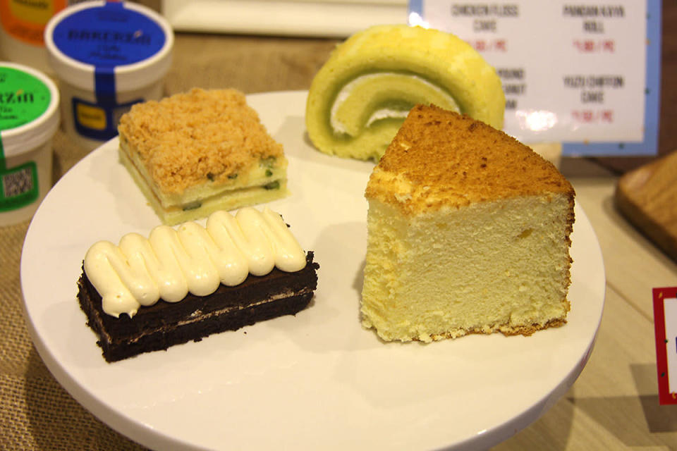 Clockwise from top right: Pandan kaya roll, yuzu chiffon cake, chocolate pound peanut butter cream cake, chicken floss cake
