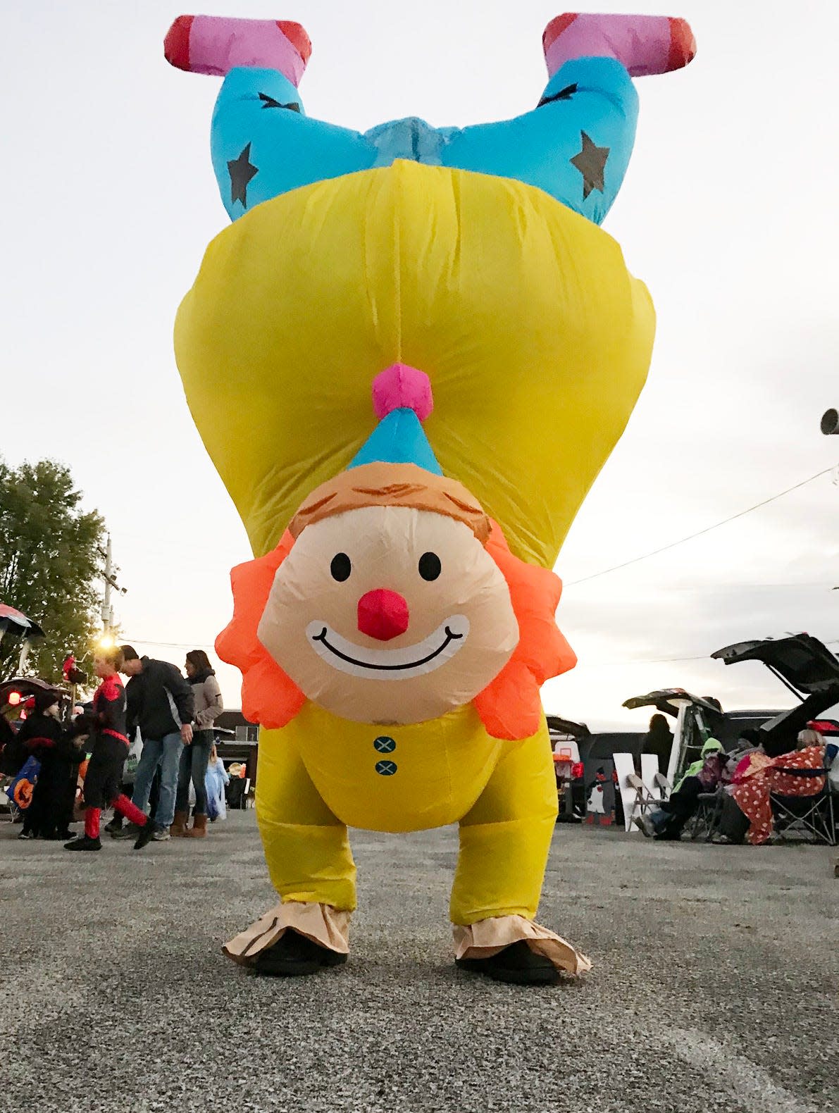 A clown moves from station to station at Costa Academy's Trunk or Treat event Saturday in the school's parking lot. District 205 schools have moved away from Halloween festivities in the classrooms.