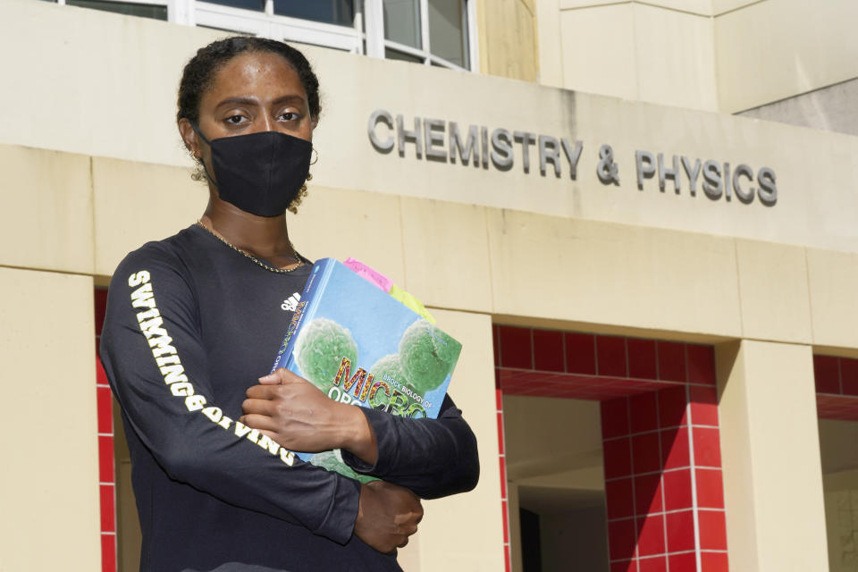 Kelsie Campbell, a student at Florida International University in Miami, poses for a photo on campus, Thursday, Oct. 8, 2020. When Campbell, who is part Jamaican and part British, heard in both the British and American media that Black and ethnic minorities were being disproportionately hurt by the pandemic, she wanted to focus on why. (AP Photo/Wilfredo Lee)