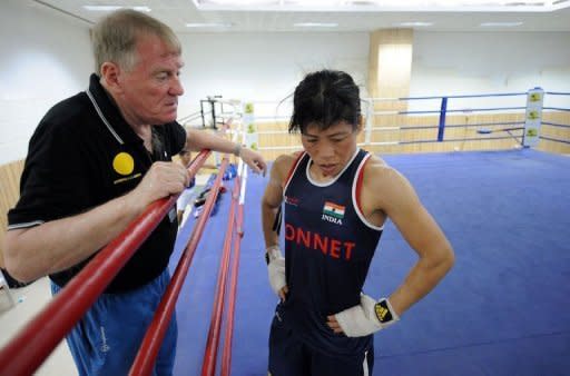 Boxing coach Charles Atkinson (L) speaks with Indian boxer MC Mary Kom during a training session in Pune. Atkinson believes her height could work to her advantage -- as shown by her triumph in the 51kg at the Asian Championships earlier this year