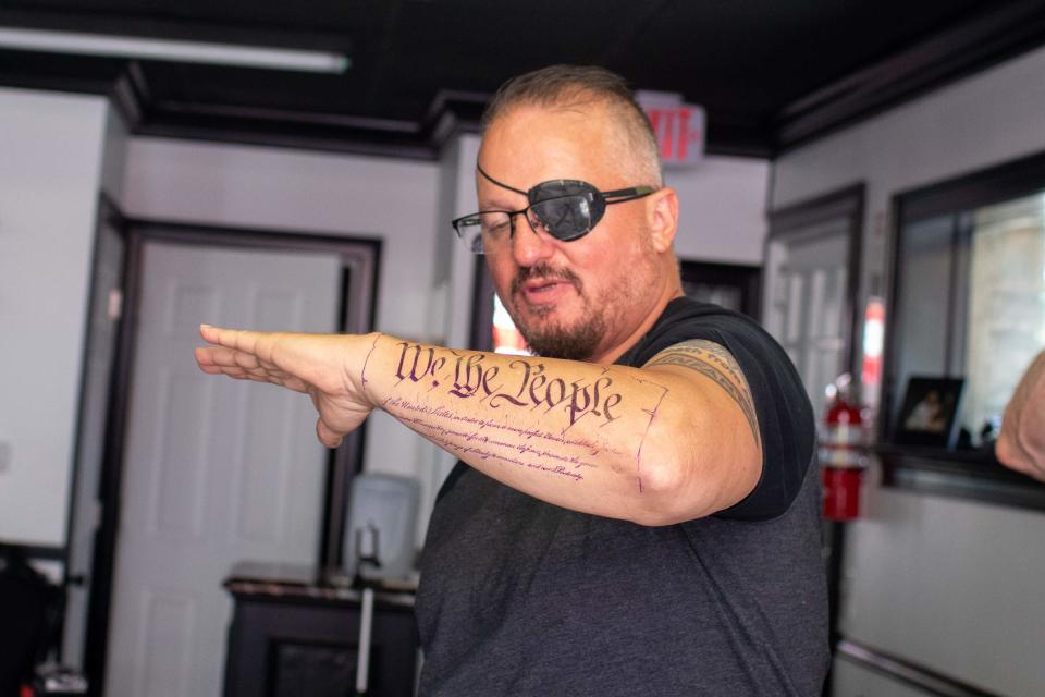 Oath Keeper President Stewart Rhodes shows off his tattoo at Casa di Dolore n Newburgh on Saturday, May 30, 2020.