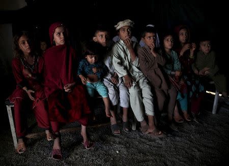 Afghan refugee children, returning from Pakistan, watch a short video clip about mines at a mines and explosives awareness program at a United Nations High Commissioner for Refugees (UNHCR) registration centre in Kabul, Afghanistan September 2, 2015. REUTERS/Ahmad Masood