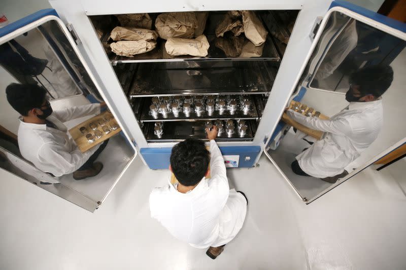 Brazilian forestry student Sanquetta separates material collected in the Amazon at the Center of Excellence in Research on Carbon Fixation in Biomass in Curitiba