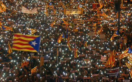 Protesters hold the lights of their mobile phones as they wave Estelada flags during a demonstration called by pro-independence associations asking for the release of jailed Catalan activists and leaders, in Barcelona, Spain, November 11, 2017. REUTERS/Albert Gea