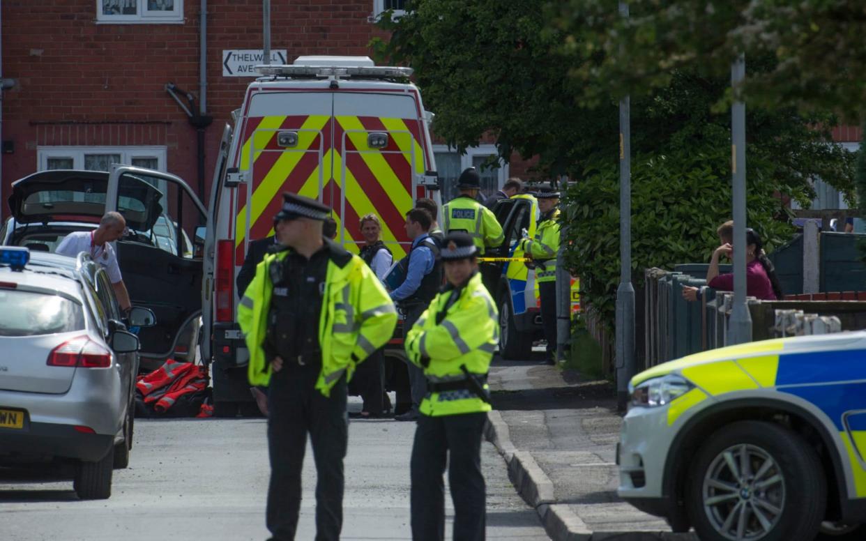 Police seal off Elsmore Road in Manchester and search an address further down the street in the aftermath of the Arena bombing - JULIAN SIMMONDS