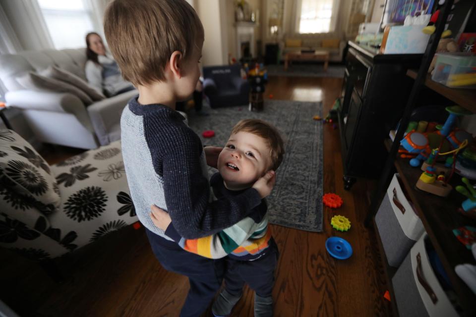 Gabriel Trainor, 4, gives his brother Macklan, 1, a hug, while playing in their home in Plymouth, Michigan, on Saturday, Feb. 4, 2023. Gabriel's moms Sally and Leanne Trainor each gave birth to one of their sons and adopted the other to ensure parental rights that don't naturally come like the ones heterosexual parents that have children together have.