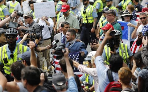 Jason Kessler, the organizer of the white rights protest, center, speaks to members of the media during the Unite the Right 2 rally in Washington, D.C - Credit: Bloomberg