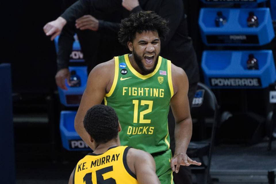 Oregon guard LJ Figueroa (12) reacts to hitting a three-point basket against Iowa during the second half of a men's college basketball game in the second round of the NCAA tournament at Bankers Life Fieldhouse in Indianapolis, Monday, March 22, 2021. (AP Photo/Paul Sancya)